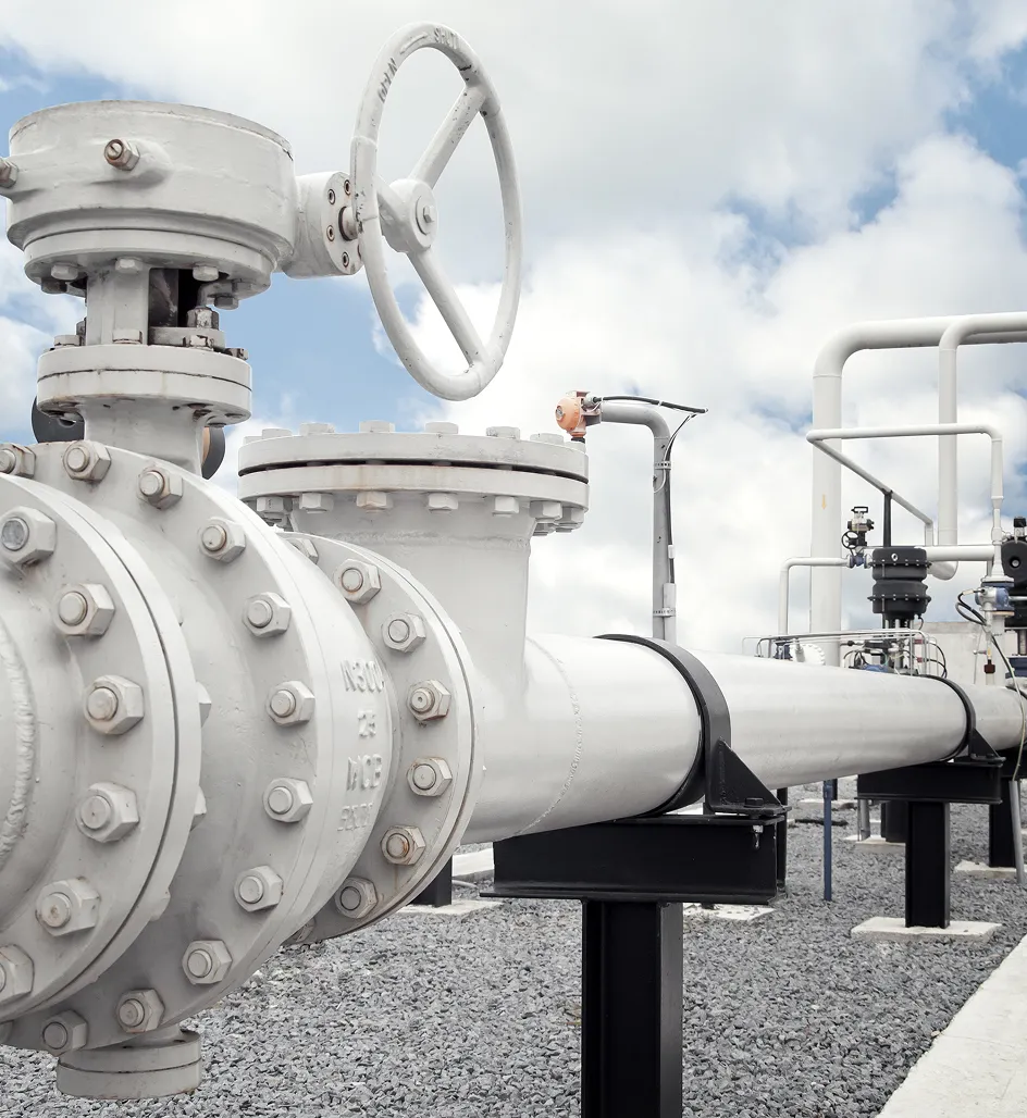 Industrial pipeline ball valves and flanged fittings at an outdoor oil and gas facility