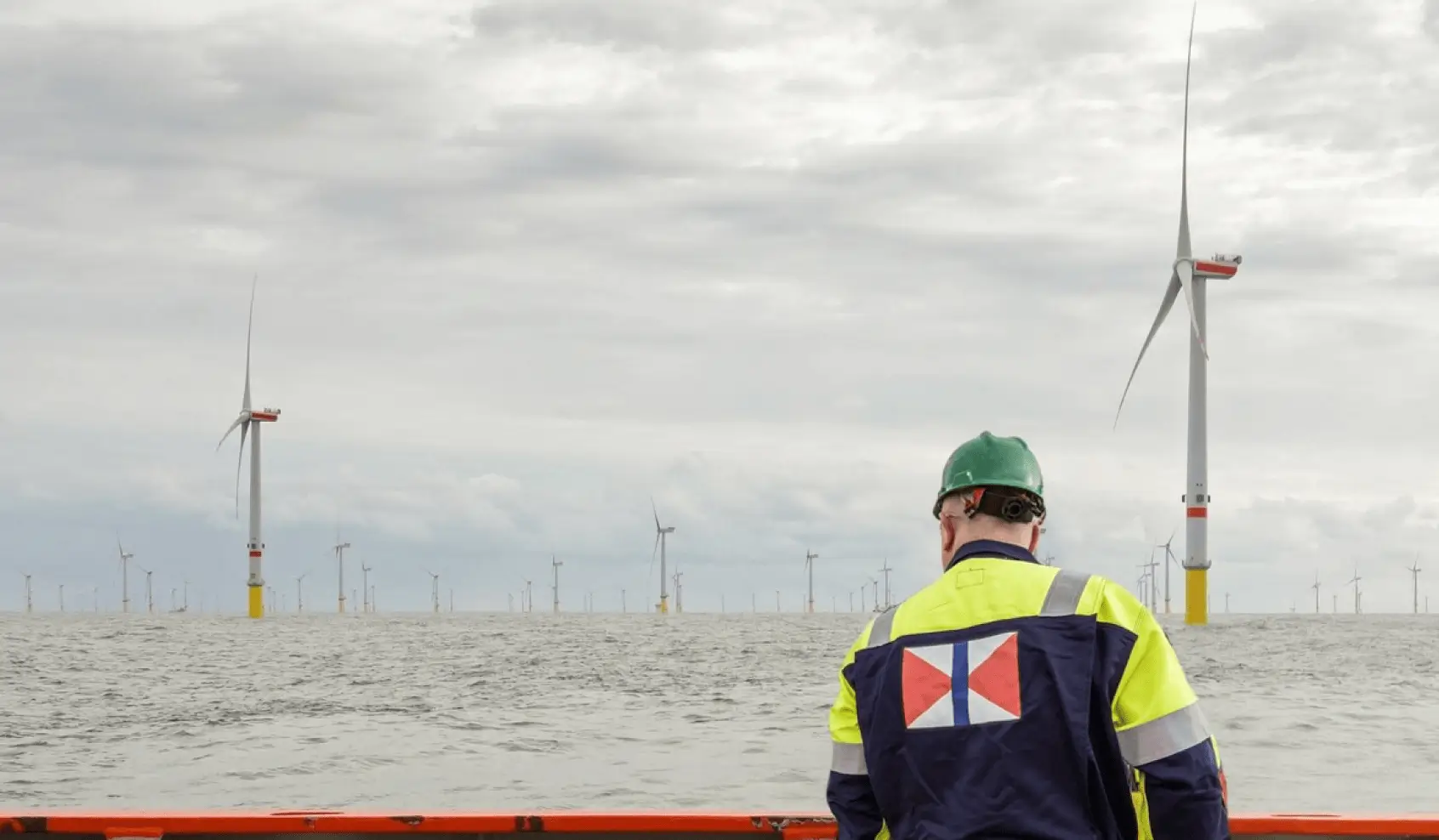 A Swire Energy engineer inspects a wind turbine farm on an offshore platform