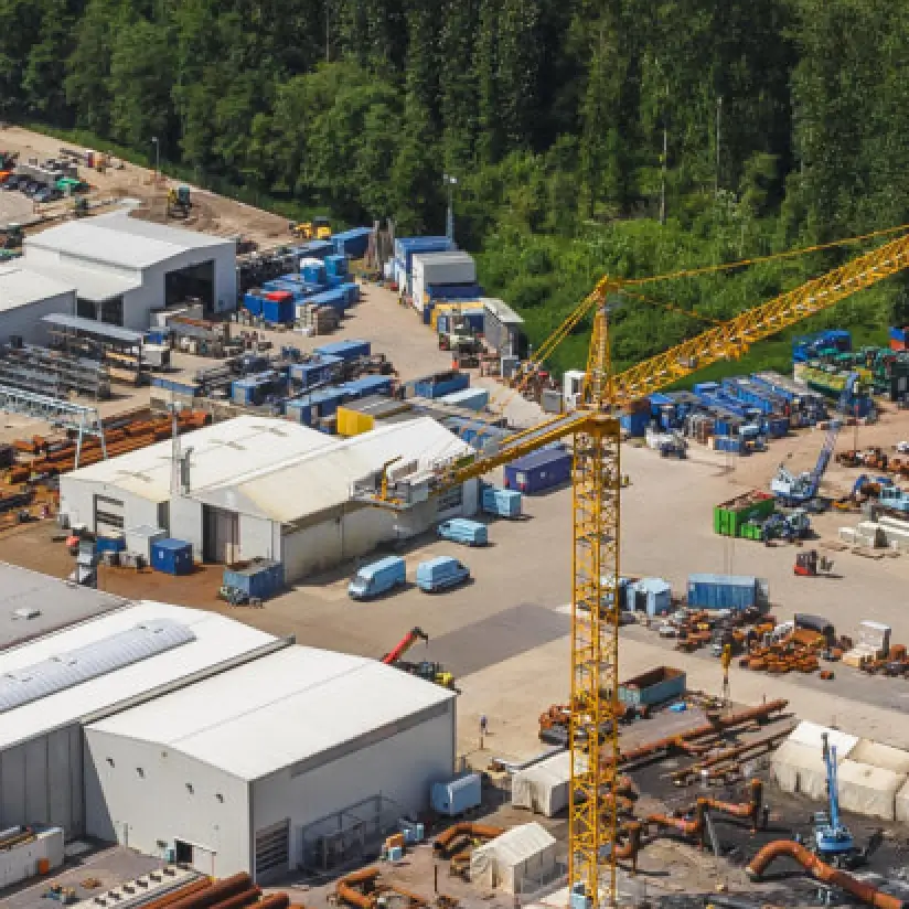 Bird's-eye view of a construction site with a yellow crane.