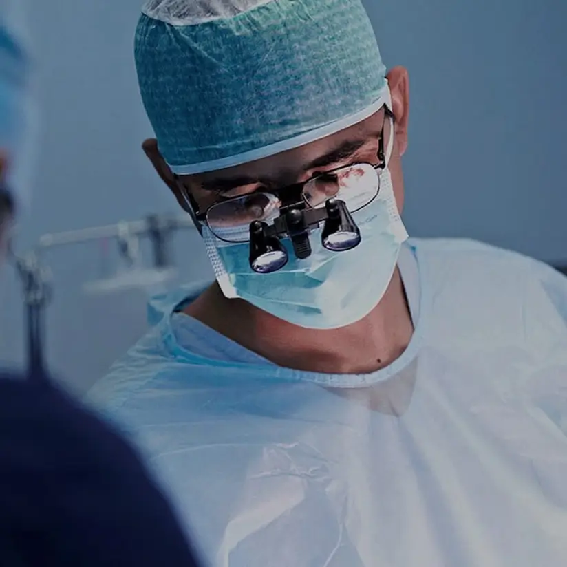 A male doctor at work in the operating room.
