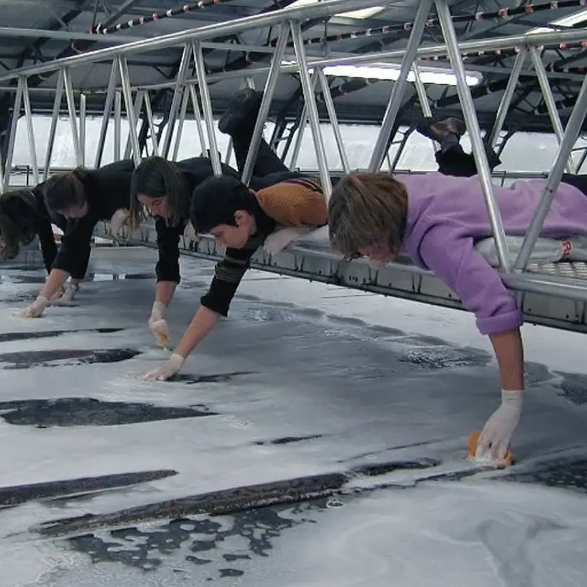 Five people are washing the fabric before its subsequent use.