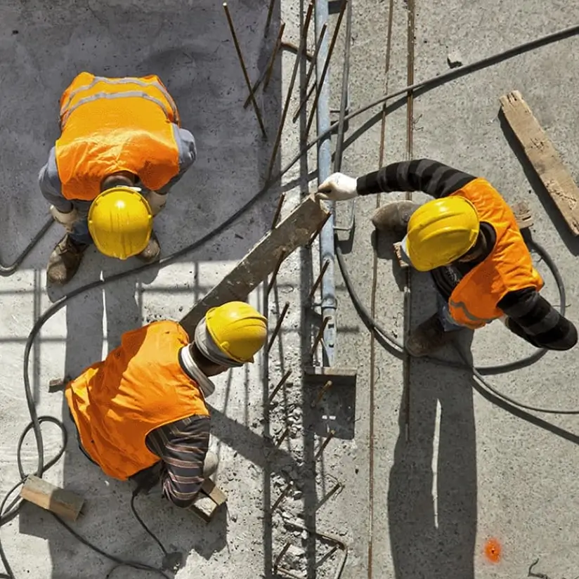 Three construction workers at work